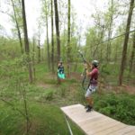 People enjoying spring outdoor activities in Lancaster, PA by ziplining in a forest