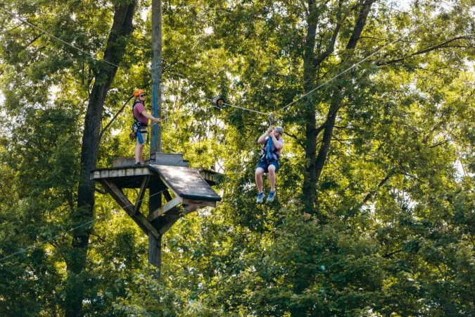 Two Men Enjoying The Refreshing Mountain Zipline Challenge Adventure Tour.